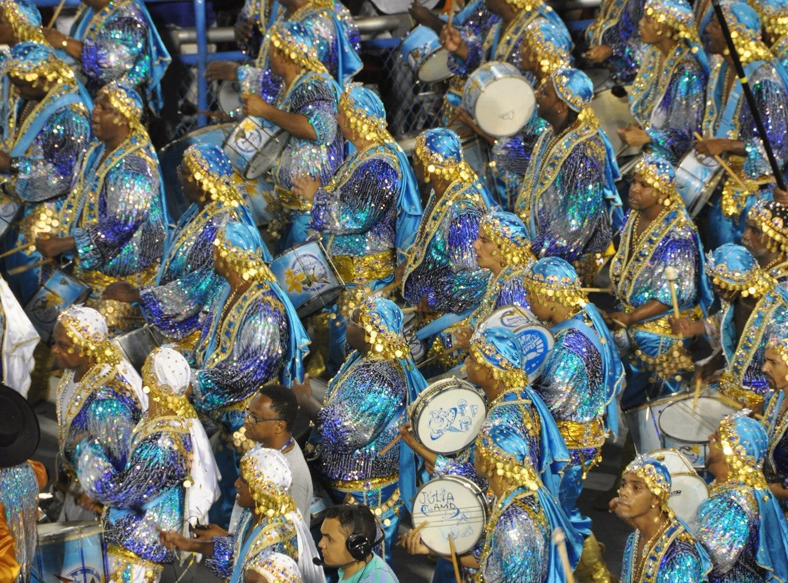Samba school drummers in blue and gold costumes parading in the Sambadrome, Rio de Janeiro